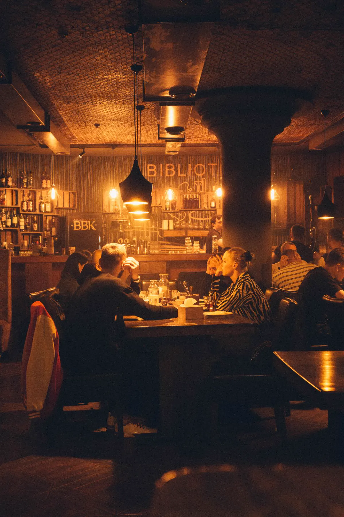 Friends around a table at a pub quiz night